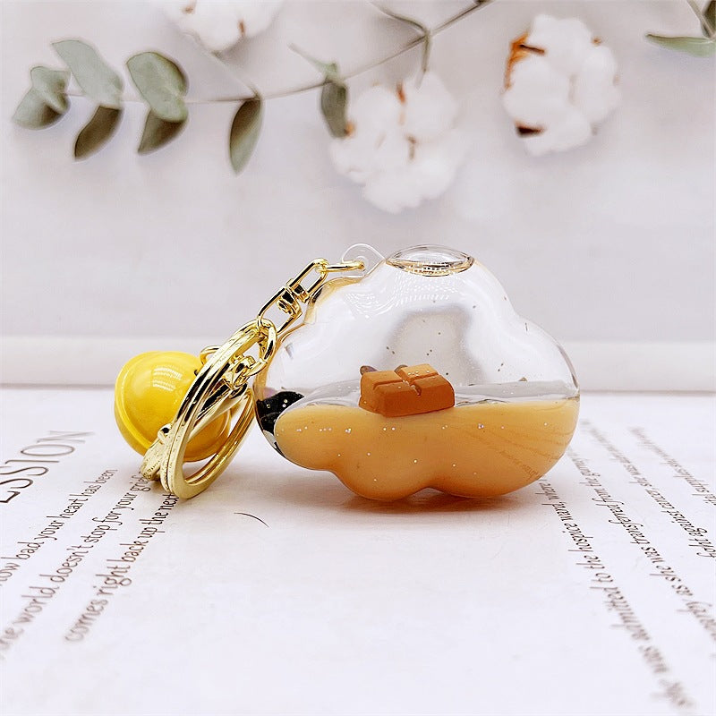 Comercio al por mayor acrílico flotando en el aceite de chocolate arenas movedizas llavero creativo